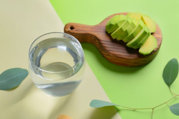 Glass,Of,Water,And,Avocado,On,Color,Background